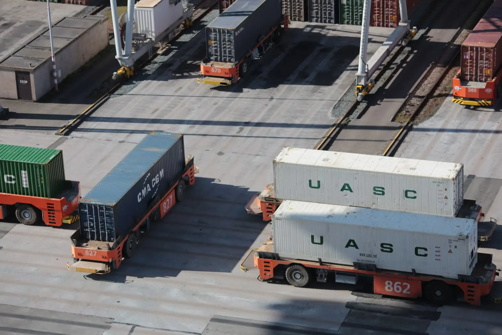 Trucks hauling shipping containers